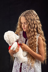 Image showing Portrait of a teenage girl with an old teddy bear, a favorite childhood toy