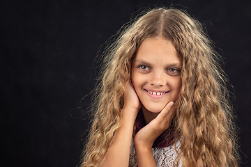 Image showing Closeup portrait of a cheerful ten year old girl who looks left