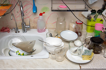 Image showing Unwashed dishes on the table of the old kitchen