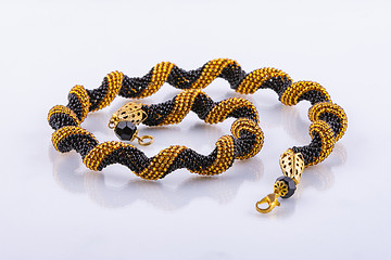 Image showing Handmade small bead bracelet in black and gold beads