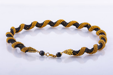 Image showing Small handmade beaded bracelet made of black and gold beads