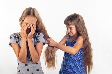 Image showing Girl pulls another girl by the hair