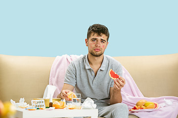 Image showing Young man suffering from allergy to citrus fruits