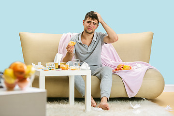 Image showing Young man suffering from allergy to citrus fruits