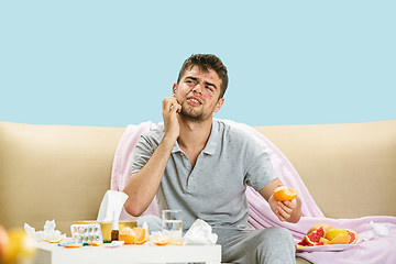 Image showing Young man suffering from allergy to citrus fruits