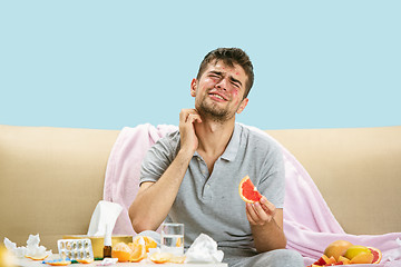 Image showing Young man suffering from allergy to citrus fruits