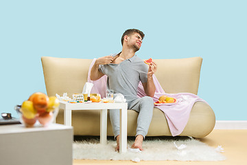 Image showing Young man suffering from allergy to citrus fruits