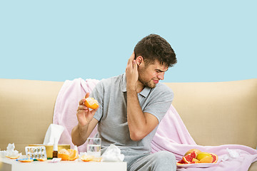 Image showing Young man suffering from allergy to citrus fruits