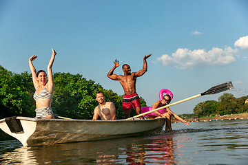 Image showing Happy group of friends having fun, laughting and swimming in river