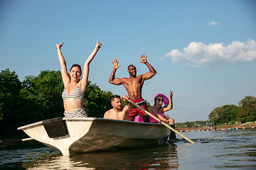 Image showing Happy group of friends having fun, laughting and swimming in river