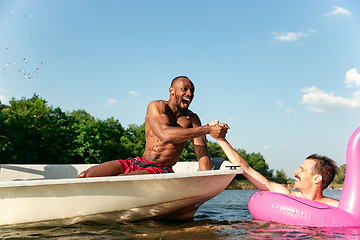 Image showing Happy friends having fun, laughting and swimming in river