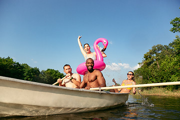 Image showing Happy group of friends having fun, laughting and swimming in river