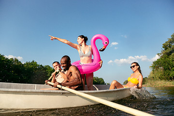 Image showing Happy group of friends having fun, laughting and swimming in river