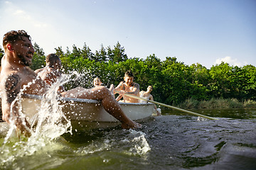 Image showing Happy group of friends having fun, laughting and swimming in river