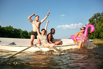 Image showing Happy group of friends having fun, laughting and swimming in river