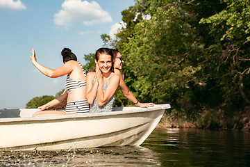 Image showing Happy group of friends having fun, laughting and swimming in river