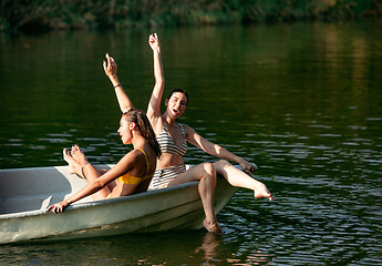 Image showing Happy group of friends having fun, laughting and swimming in river