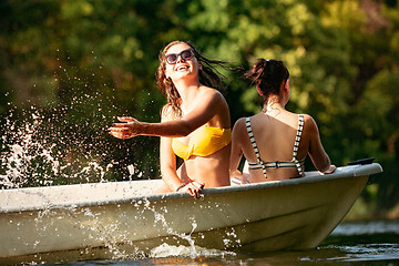 Image showing Happy group of friends having fun, laughting and swimming in river