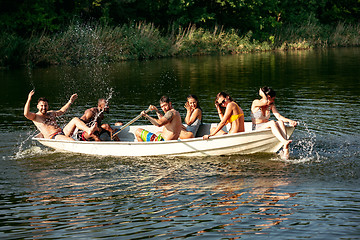 Image showing Happy group of friends having fun, laughting and swimming in river