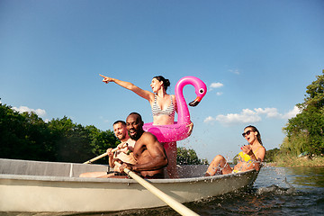 Image showing Happy group of friends having fun, laughting and swimming in river