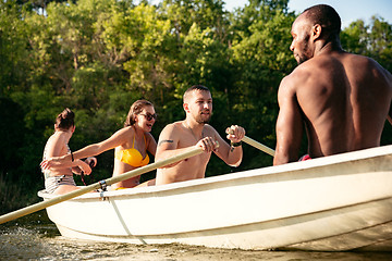 Image showing Happy group of friends having fun, laughting and swimming in river