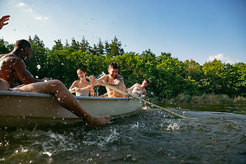 Image showing Happy group of friends having fun, laughting and swimming in river