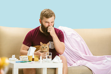 Image showing Young man suffering from allergy to cat hair