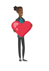 Image showing Young african-american man holding a big heart.