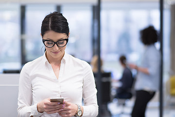 Image showing Elegant Woman Using Mobile Phone in startup office building