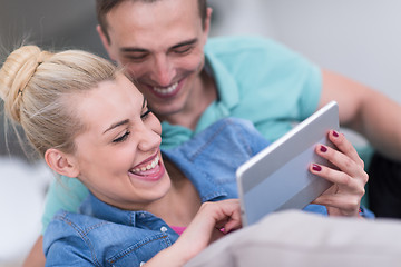 Image showing couple relaxing at  home with tablet computers