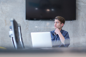 Image showing businessman working using a laptop in startup office