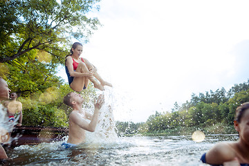 Image showing Enjoying river party with friends. Group of beautiful happy young people at the river together