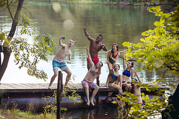 Image showing Enjoying river party with friends. Group of beautiful happy young people at the river together