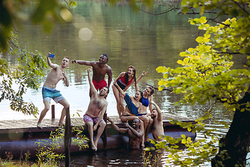 Image showing Enjoying river party with friends. Group of beautiful happy young people at the river together