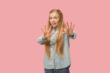 Image showing Let me think. Doubtful pensive woman with thoughtful expression making choice against pink background