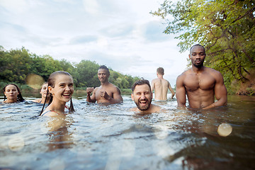 Image showing Enjoying river party with friends. Group of beautiful happy young people at the river together