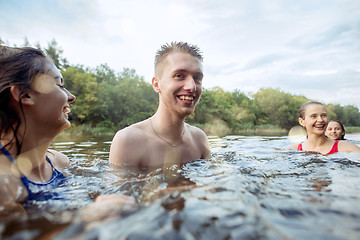 Image showing Enjoying river party with friends. Group of beautiful happy young people at the river together