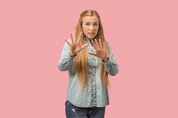 Image showing Let me think. Doubtful pensive woman with thoughtful expression making choice against pink background