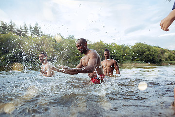 Image showing Enjoying river party with friends. Group of beautiful happy young people at the river together