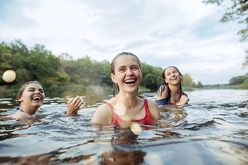 Image showing Enjoying river party with friends. Group of beautiful happy young people at the river together