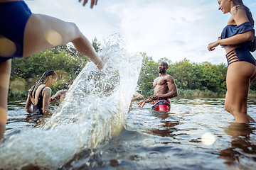 Image showing Enjoying river party with friends. Group of beautiful happy young people at the river together