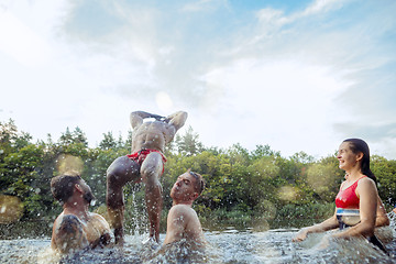 Image showing Enjoying river party with friends. Group of beautiful happy young people at the river together