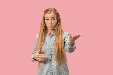 Image showing Beautiful female half-length portrait isolated on pink studio backgroud. The young emotional surprised woman