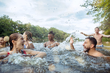 Image showing Enjoying river party with friends. Group of beautiful happy young people at the river together