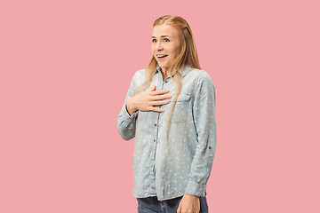 Image showing The happy business woman standing and smiling against pink background.