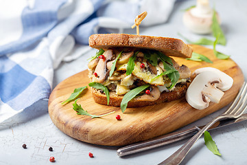 Image showing Mushroom sandwich with scrambled eggs and arugula.