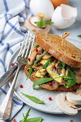 Image showing Slices of toasted bread with egg and mushrooms.