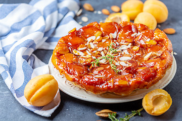 Image showing Apricot tarte tatin pie with thyme and almonds.