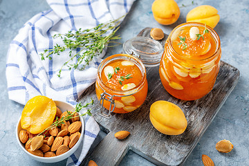Image showing Jars of homemade apricot jam with almonds.