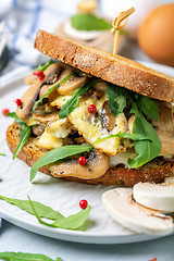 Image showing Sandwich with omelet, greens and mushrooms close-up.